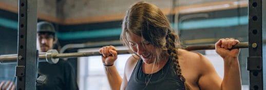 A coach guiding clients through specialty strength training in Fairfax, focusing on safe, functional movement.